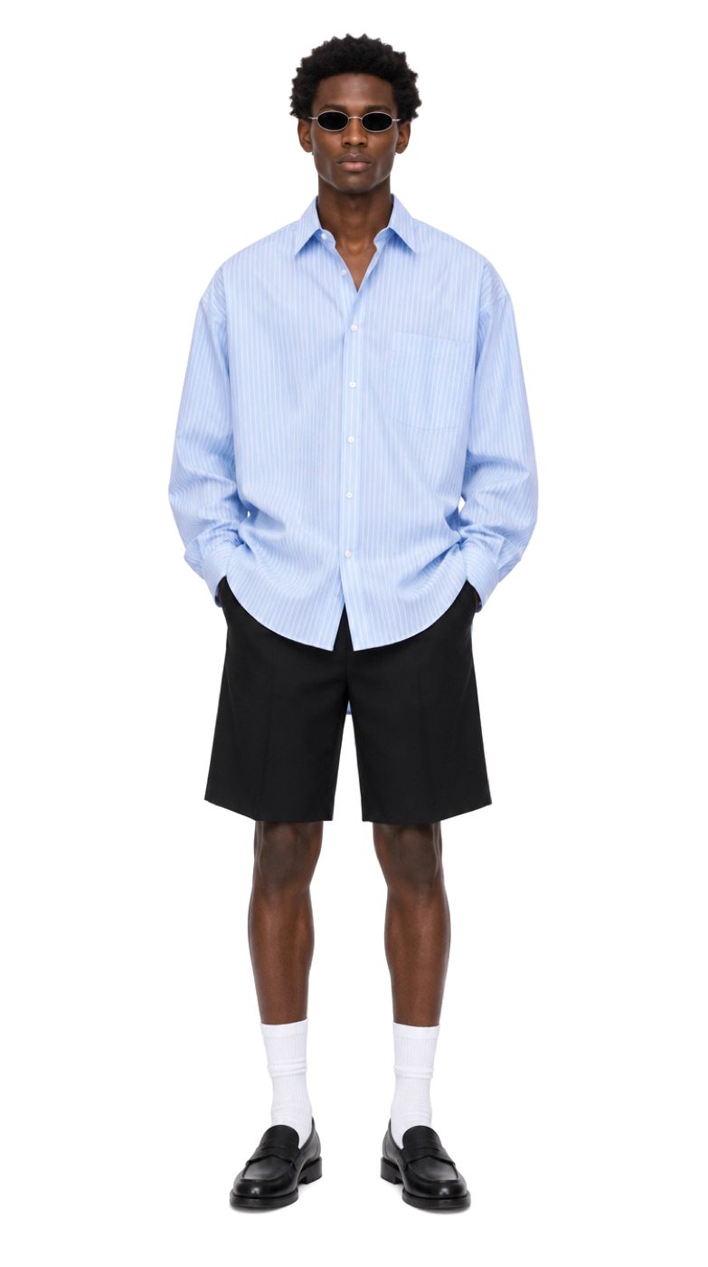 Try-on of a striped blue shirt and black shorts